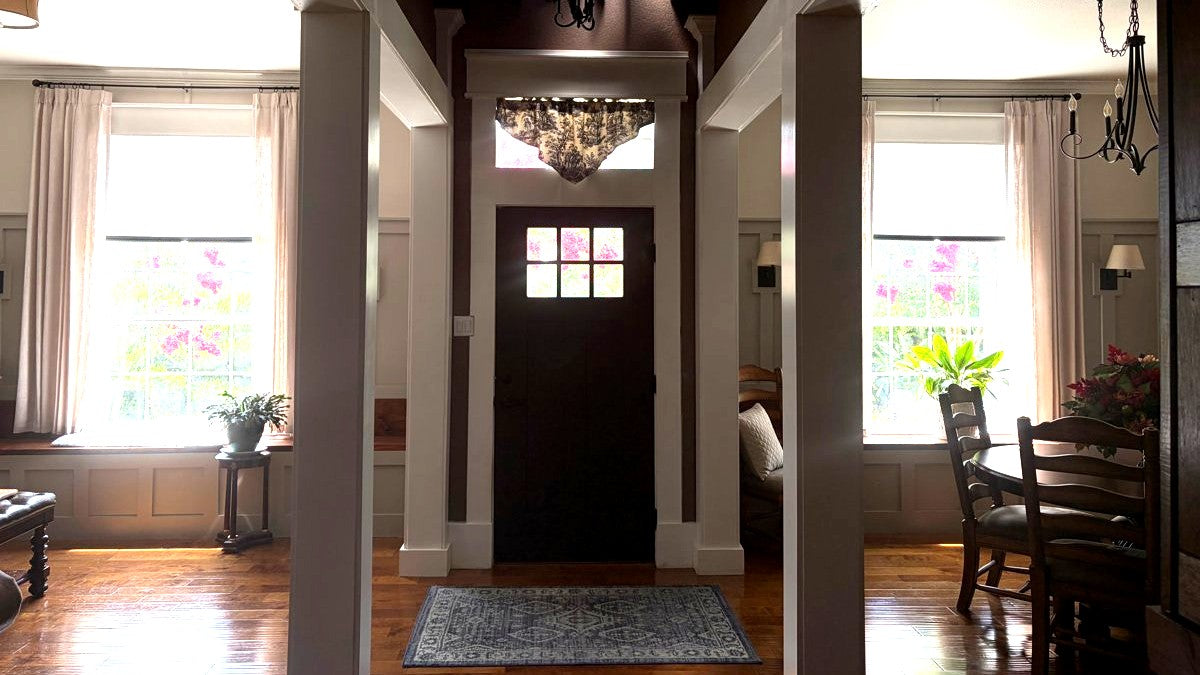 Warm entryway of a home, sunlight across the floor